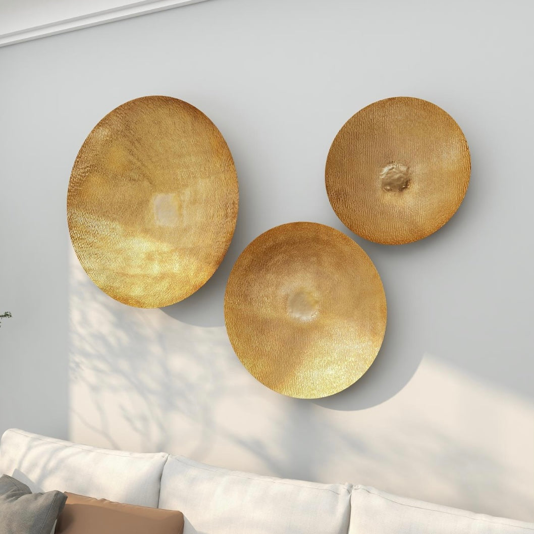 Large gold metallic wall mounted disk