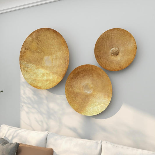 Large gold metallic wall mounted disk